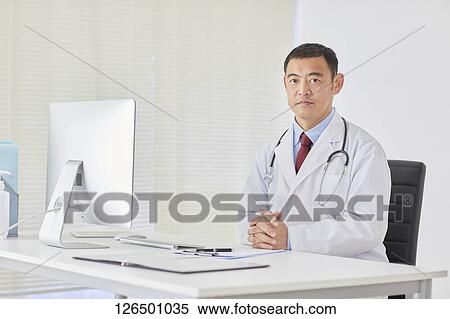 Stock Photography - Japanese doctor in the studio. Fotosearch
