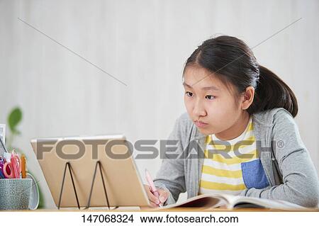 Japanese junior high schoolgirl studying remotely View Large Photo Image Picture - Japanese junior high schoolgirl studying remotely. Fotosearch