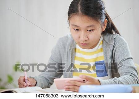Japanese junior high schoolgirl studying remotely View Large Photo Image Stock Image - Japanese junior high schoolgirl studying remotely. Fotosearch