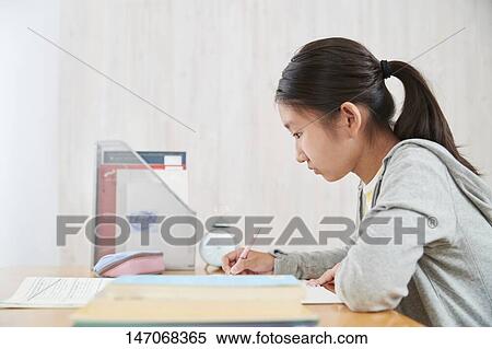 Stock Photography - Japanese junior high schoolgirl studying remotely. Fotosearch