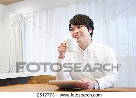 Stock Image - Japanese man at home. Fotosearch