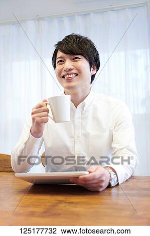 Stock Image - Japanese man at home. Fotosearch
