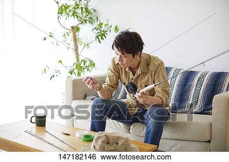 Japanese man cleaning fishing rod at home View Large Photo Image Stock Photograph - Japanese man cleaning fishing rod at home. Fotosearch