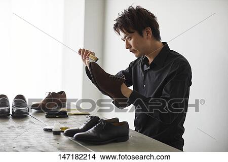 Japanese man cleaning shoes at home View Large Photo Image Picture - Japanese man cleaning shoes at home. Fotosearch