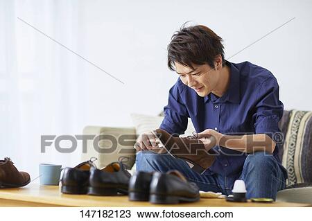 Japanese man cleaning shoes at home View Large Photo Image Stock Image - Japanese man cleaning shoes at home. Fotosearch