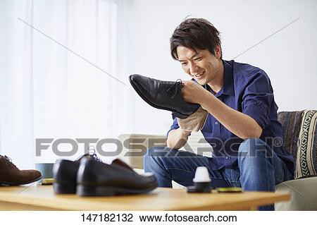 Japanese man cleaning shoes at home View Large Photo Image Stock Image - Japanese man cleaning shoes at home. Fotosearch