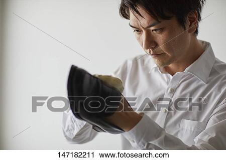 Japanese man cleaning shoes at home View Large Photo Image Stock Image - Japanese man cleaning shoes at home. Fotosearch