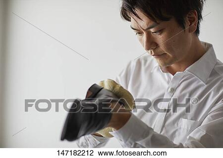 Japanese man cleaning shoes at home View Large Photo Image Stock Image - Japanese man cleaning shoes at home. Fotosearch
