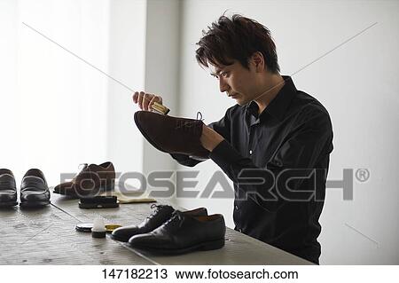 Japanese man cleaning shoes at home View Large Photo Image Stock Image - Japanese man cleaning shoes at home. Fotosearch