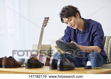 Japanese man cleaning shoes at home View Large Photo Image Stock Photo - Japanese man cleaning shoes at home. Fotosearch
