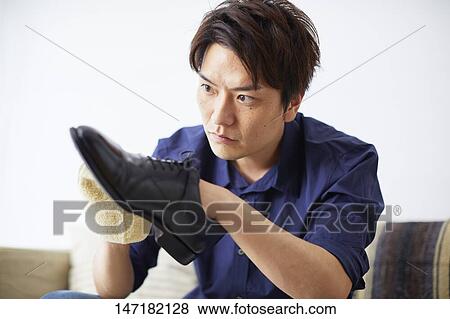 Japanese man cleaning shoes at home View Large Photo Image Stock Photo - Japanese man cleaning shoes at home. Fotosearch