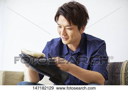 Japanese man cleaning shoes at home View Large Photo Image Stock Photo - Japanese man cleaning shoes at home. Fotosearch