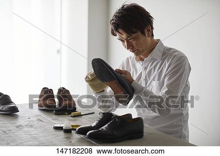 Japanese man cleaning shoes at home View Large Photo Image Stock Photo - Japanese man cleaning shoes at home. Fotosearch