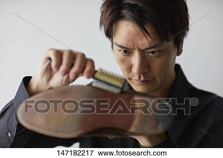 Japanese man cleaning shoes at home View Large Photo Image Stock Photo - Japanese man cleaning shoes at home. Fotosearch