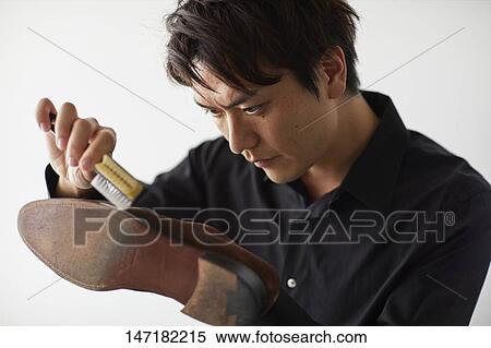Japanese man cleaning shoes at home View Large Photo Image Stock Photography - Japanese man cleaning shoes at home. Fotosearch
