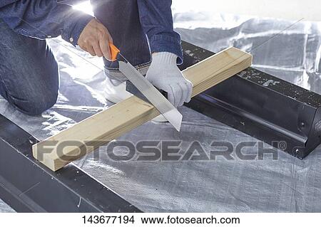 Picture - Japanese man doing DIY. Fotosearch