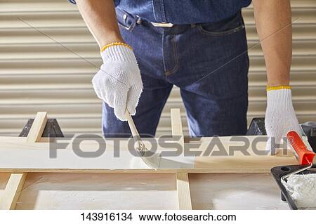 Picture - Japanese man doing DIY. Fotosearch