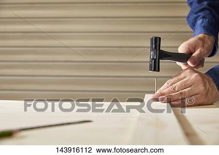 Stock Image - Japanese man doing DIY. Fotosearch