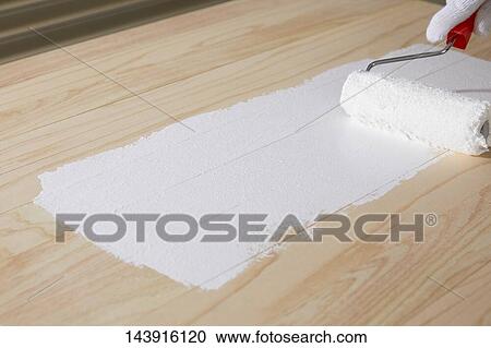 Stock Image - Japanese man doing DIY. Fotosearch