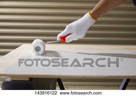 Stock Image - Japanese man doing DIY. Fotosearch