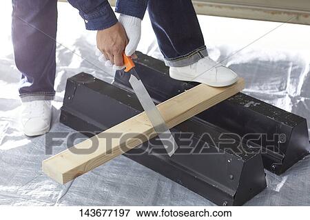 Stock Photo - Japanese man doing DIY. Fotosearch