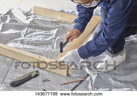 Japanese man doing DIY View Large Photo Image Stock Photo - Japanese man doing DIY. Fotosearch