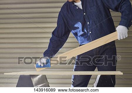 Stock Photo - Japanese man doing DIY. Fotosearch