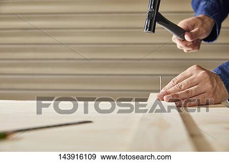 Stock Photo - Japanese man doing DIY. Fotosearch