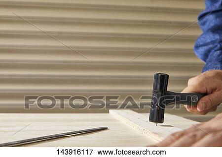 Stock Photo - Japanese man doing DIY. Fotosearch