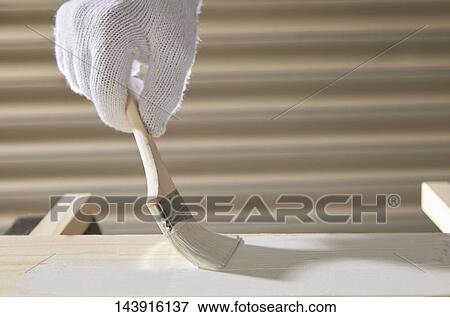 Stock Photo - Japanese man doing DIY. Fotosearch