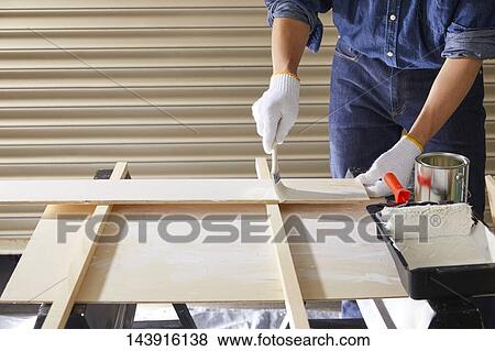 Stock Photo - Japanese man doing DIY. Fotosearch