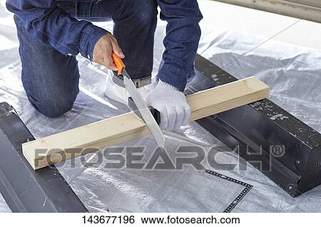 Stock Photograph - Japanese man doing DIY. Fotosearch