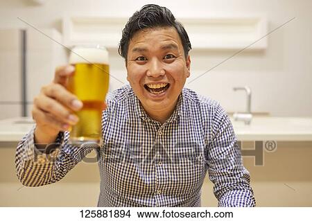 Japanese man drinking at home remote drinking View Large Photo Image Picture - Japanese man drinking at home remote drinking. Fotosearch