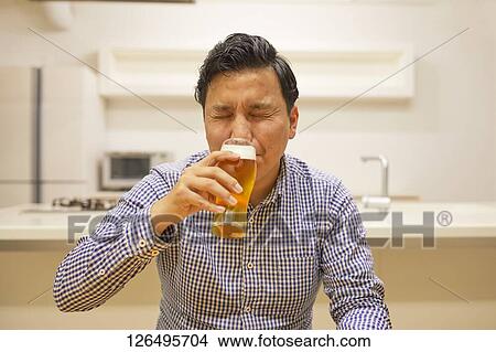 Japanese man drinking at home remote drinking View Large Photo Image Picture - Japanese man drinking at home remote drinking. Fotosearch