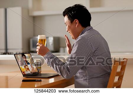 Japanese man drinking at home remote drinking View Large Photo Image Stock Image - Japanese man drinking at home remote drinking. Fotosearch