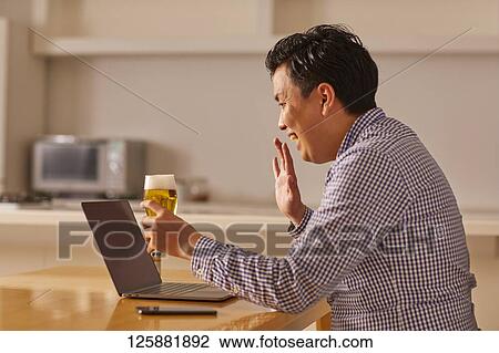 Japanese man drinking at home remote drinking View Large Photo Image Stock Image - Japanese man drinking at home remote drinking. Fotosearch
