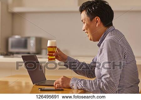 Japanese man drinking at home remote drinking View Large Photo Image Stock Image - Japanese man drinking at home remote drinking. Fotosearch