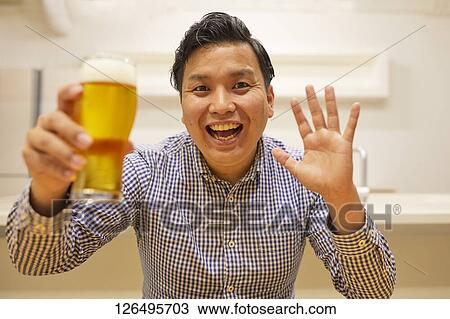 Japanese man drinking at home remote drinking View Large Photo Image Stock Image - Japanese man drinking at home remote drinking. Fotosearch