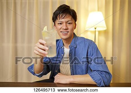 Japanese man drinking at home remote drinking View Large Photo Image Stock Image - Japanese man drinking at home remote drinking. Fotosearch