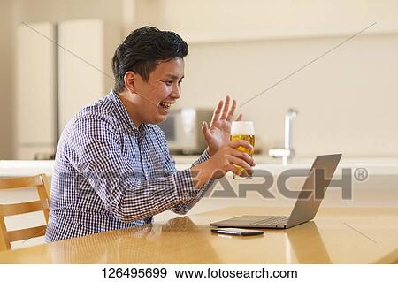 Japanese man drinking at home remote drinking View Large Photo Image Stock Photo - Japanese man drinking at home remote drinking. Fotosearch