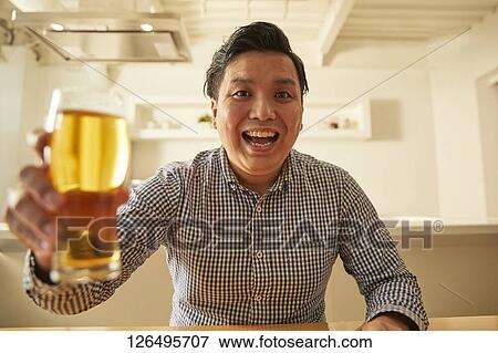 Japanese man drinking at home remote drinking View Large Photo Image Stock Photo - Japanese man drinking at home remote drinking. Fotosearch