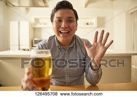 Japanese man drinking at home remote drinking View Large Photo Image Stock Photo - Japanese man drinking at home remote drinking. Fotosearch