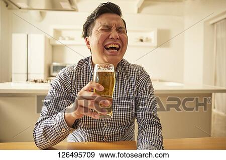 Japanese man drinking at home remote drinking View Large Photo Image Stock Photo - Japanese man drinking at home remote drinking. Fotosearch