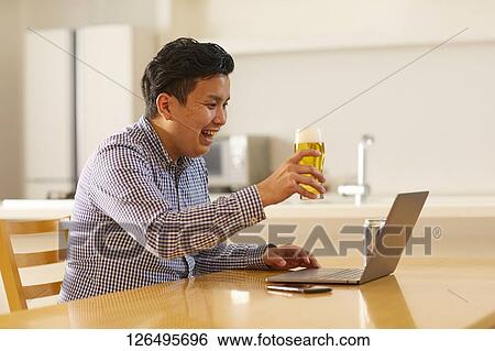 Japanese man drinking at home remote drinking View Large Photo Image Stock Photograph - Japanese man drinking at home remote drinking. Fotosearch
