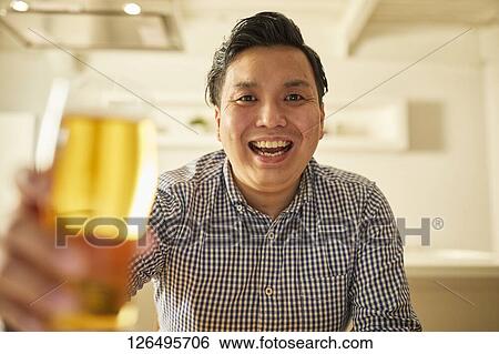 Japanese man drinking at home remote drinking View Large Photo Image Stock Photograph - Japanese man drinking at home remote drinking. Fotosearch