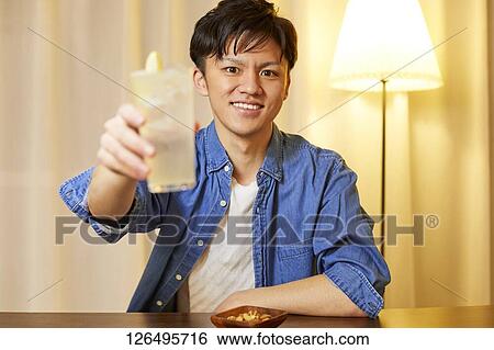 Japanese man drinking at home remote drinking View Large Photo Image Stock Photograph - Japanese man drinking at home remote drinking. Fotosearch