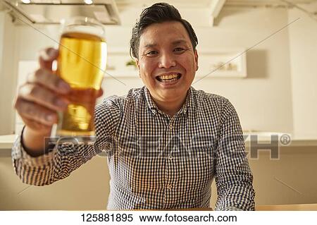 Japanese man drinking at home remote drinking View Large Photo Image Stock Photography - Japanese man drinking at home remote drinking. Fotosearch