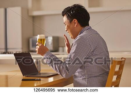 Japanese man drinking at home remote drinking View Large Photo Image Stock Photography - Japanese man drinking at home remote drinking. Fotosearch