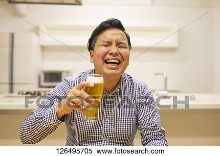 Japanese man drinking at home remote drinking View Large Photo Image Stock Photography - Japanese man drinking at home remote drinking. Fotosearch