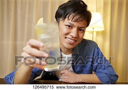 Japanese man drinking at home remote drinking View Large Photo Image Stock Photography - Japanese man drinking at home remote drinking. Fotosearch
